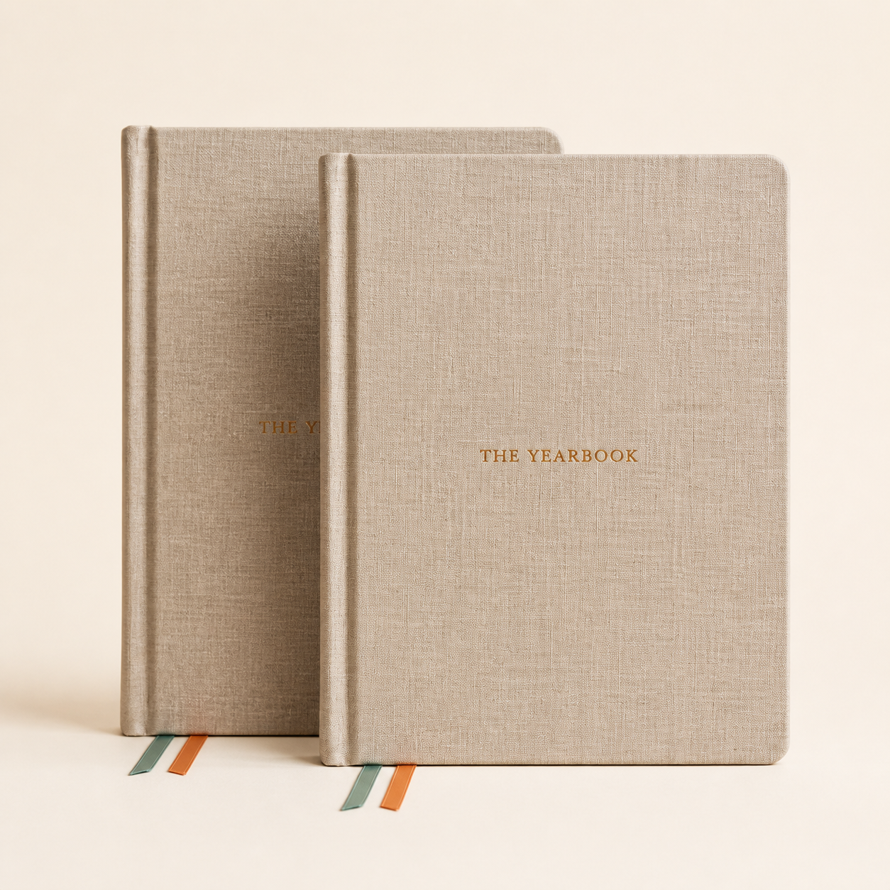 Two copies of The Yearbook 2027 annual planner in a warm studio product photo.